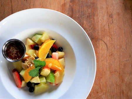 Mix fruit salad with special sauce on the white plateの写真素材