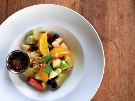 Mix fruit salad with special sauce on the white plateの写真素材