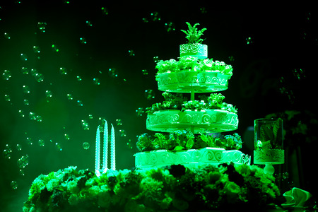 plant wedding cake 3 caddles flowing bubble green spotlight black backgroundの写真素材