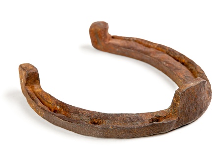 One old rusty horseshoe on a white backgroundの写真素材