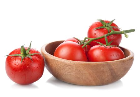 brush tomatoes in a wooden bowl isolated on white backgroundの写真素材