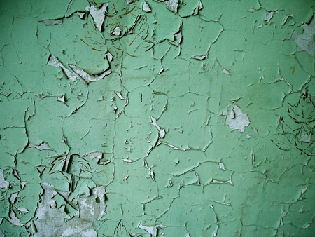 Old expanded green paint on the grey wall                           の写真素材