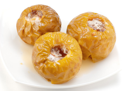 baked apples in a white plate on a whiteの写真素材