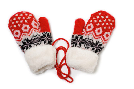 a pair of red baby mittens with pattern on white backgroundの写真素材