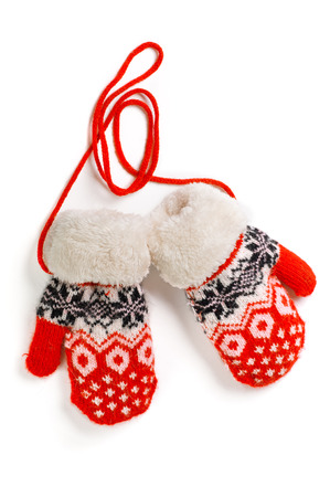 a pair of red baby mittens with pattern on white backgroundの写真素材