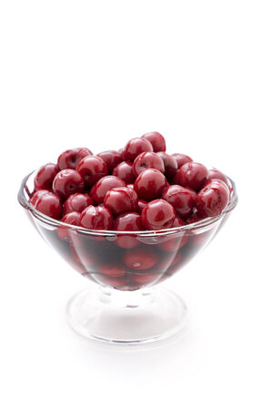 cherry compote in a glass vase on white backgroundの写真素材