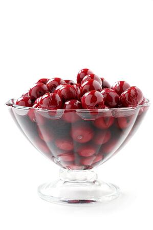 cherry compote in a glass vase on white backgroundの写真素材