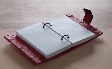 Open Red Notebook  on the  wooden backgroundの写真素材
