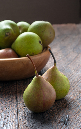 Green Pears in Wooden Plate On The Tableの写真素材
