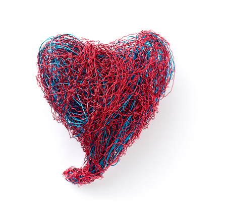The heart of bent wire isolated on white backgroundの写真素材