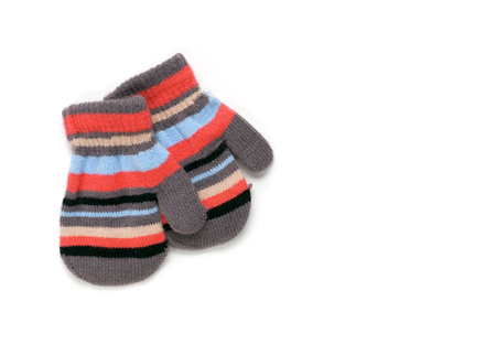 two knitted striped baby mittens isolated on white backgroundの写真素材