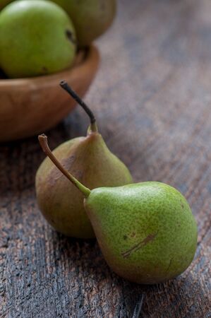 Green Pears in Wooden Plate On The Tableの写真素材
