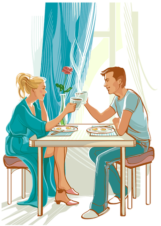 Happy couple has breakfast in kitchen.の写真素材