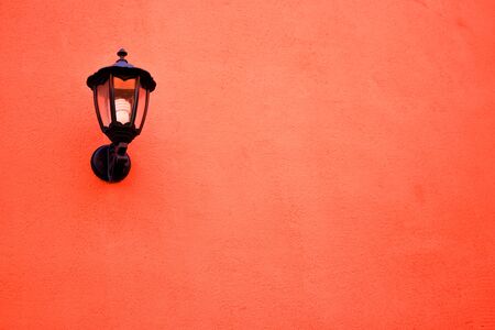Orange lamp on the wallの写真素材