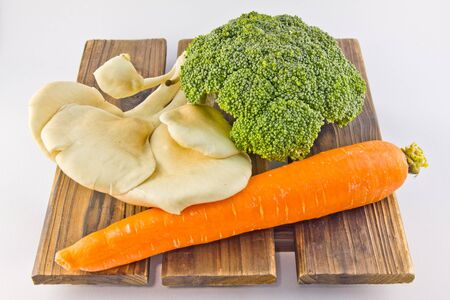  fresh vegetables on wood, white background.の写真素材