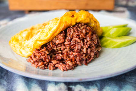 Omelet served with brown riceの写真素材