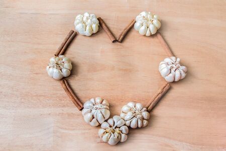 Garlic, spices, making a heart shape.の写真素材