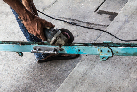 Old door old house repairing the steel door with tools on cement floor. working outdoors.の写真素材