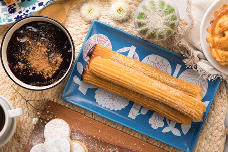 Cup of coffee and churros on the table, top view Assorted peruvian desserts peru sweet food buffet...