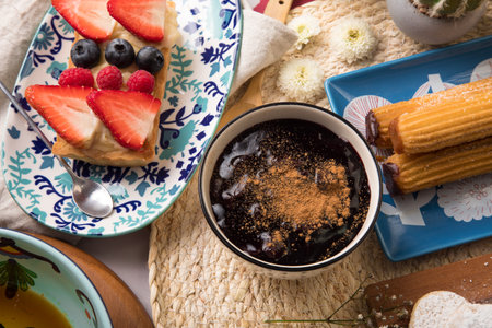 Close up view of a cup of coffee with cakes and fruits. Assorted peruvian desserts peru sweet food buffet table brunchの写真素材