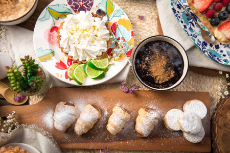 Coffee and pastries on a wooden table, top view Assorted peruvian desserts peru sweet food buffet...