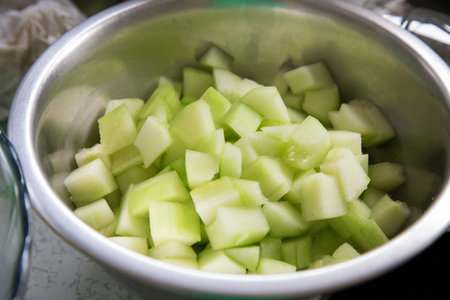 Sliced cucumber in a metal bowl. Select focus.の写真素材