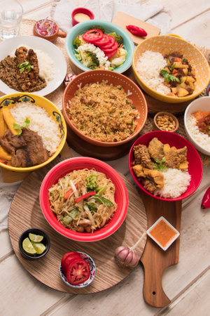 Assorted Asian dishes including rice, vegetables, meat, fish, chicken Peruvian buffet table Assorted food dishes gourmet sea food Peru traditionalの写真素材