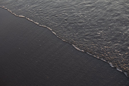 Sea waves on the beach at sunset, close-up of photoの写真素材