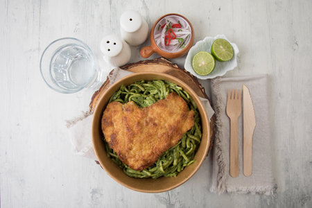Fried fish fillet with green pesto sauce and lime.の写真素材