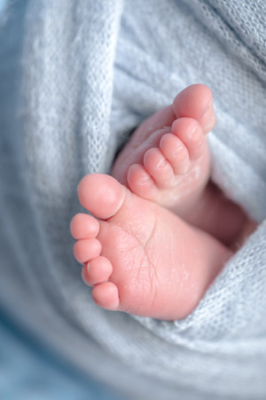 Feet of a newborn baby, close-up, soft focus