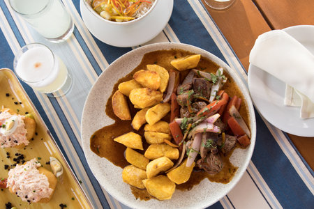 Dish with beef, potatoes and vegetables on a table in a restaurantの写真素材