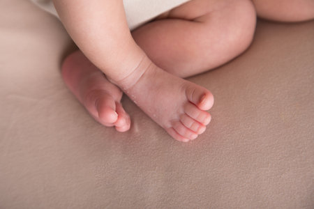 Feet of a newborn baby on a light background, closeupの写真素材