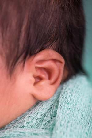 Close up of a newborn baby's ear, shallow depth of field