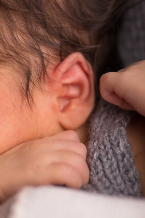 Closeup of a newborn baby's ear, shallow depth of field