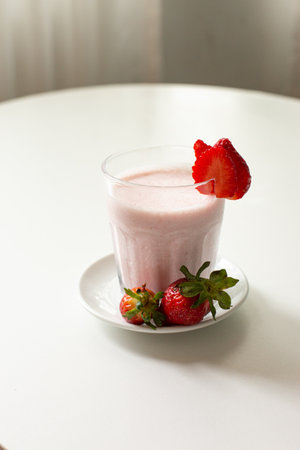 strawberry milkshake with fresh strawberries on a white backgroundの写真素材