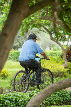 Asian senior man riding bicycle in the park, healthy lifestyle concept.の写真素材