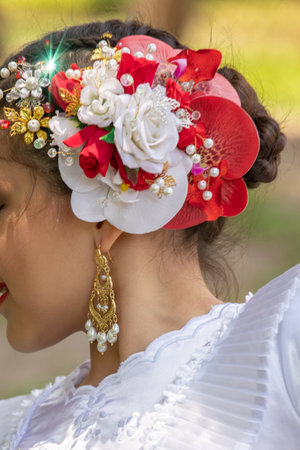 Thai woman in traditional dress with flower headband, Thailand.の写真素材