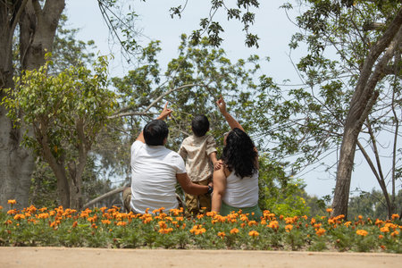 Couple sitting on the ground and looking at the flower garden.