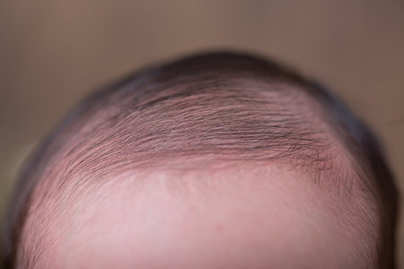Newborn baby's hair on a brown background. Close-up.の写真素材