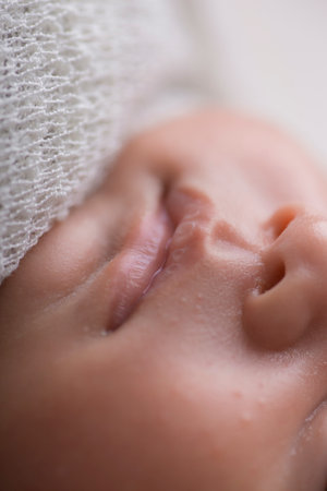 Close up of newborn baby's face with mouth open, shallow depth of fieldの写真素材