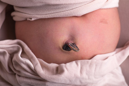 Close-up of a sick baby with a wound on the stomachの写真素材