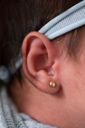 Close-up of a child's ear with a hearing aid.