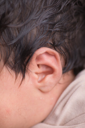Close-up of a newborn baby's ear. Shallow depth of fieldの写真素材