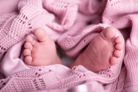 Newborn baby feet on pink blanket, closeup. Baby care conceptの写真素材
