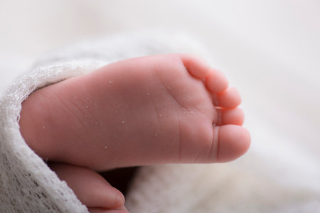 Newborn baby foot, close-up, selective focus, shallow DOFの写真素材