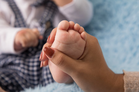 Close up of a mother holding her newborn baby feet, shallow depth of fieldの写真素材