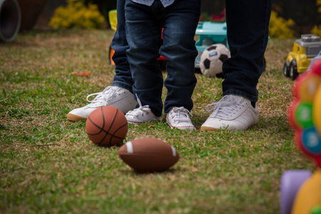 Cute little boy and girl playing with a ball on the grassの写真素材