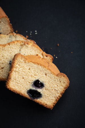 Freshly baked blueberry cake on a black background. Toned.の写真素材