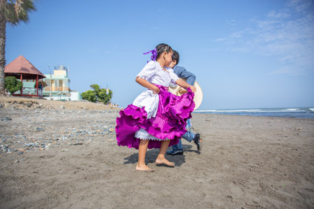 Marinera dancers peruvian dance traditional Peru Mother and daughter dancing on the beach at the day time. Concept of friendly family.の写真素材