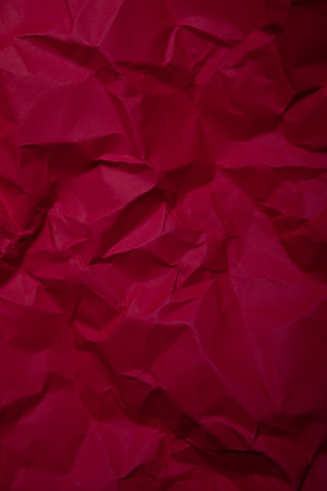 Red crumpled paper as a background texture, close-upの写真素材